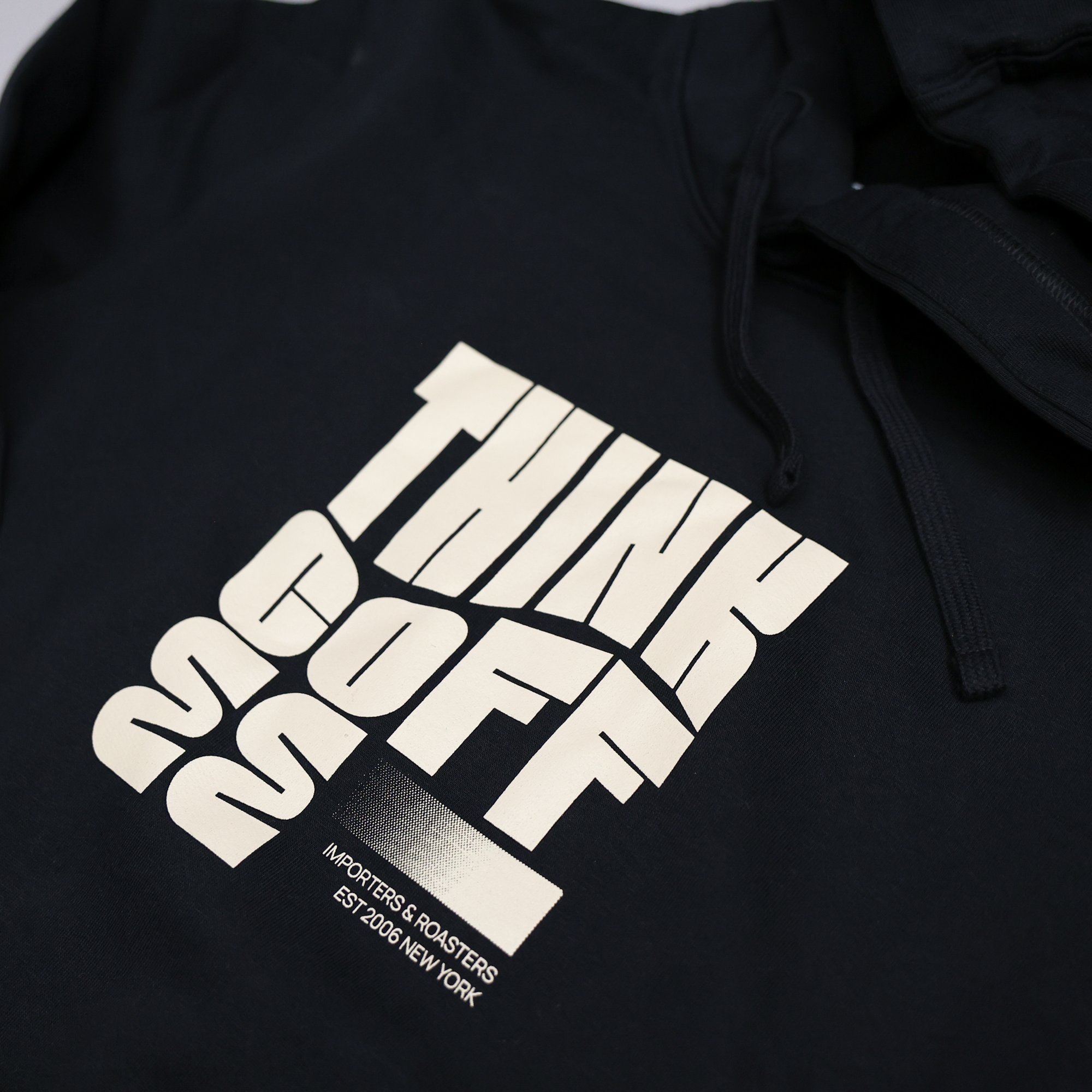 Black hoodie with white text design on a plain background