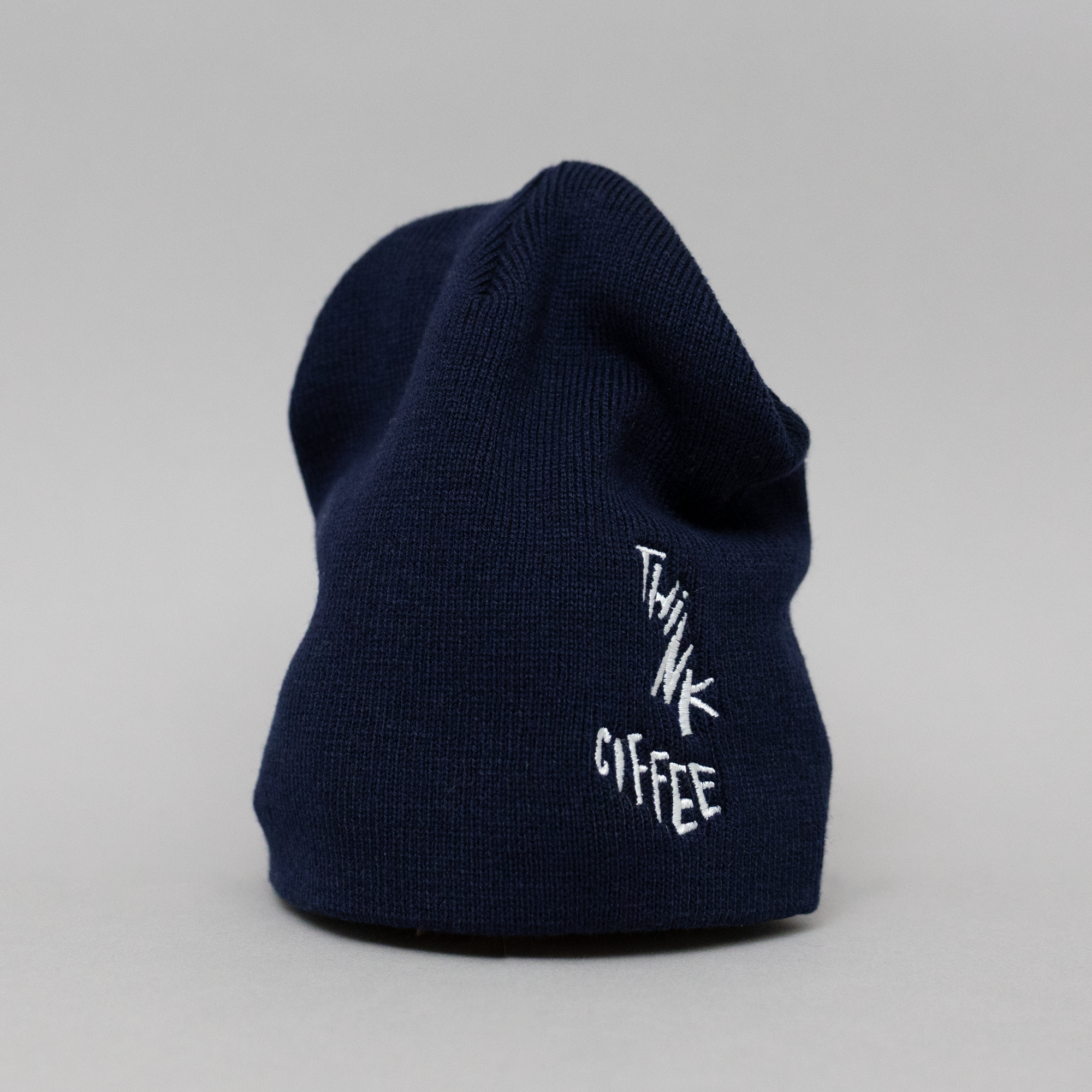 Navy blue beanie with 'THINK COFFEE' text on a light gray background
