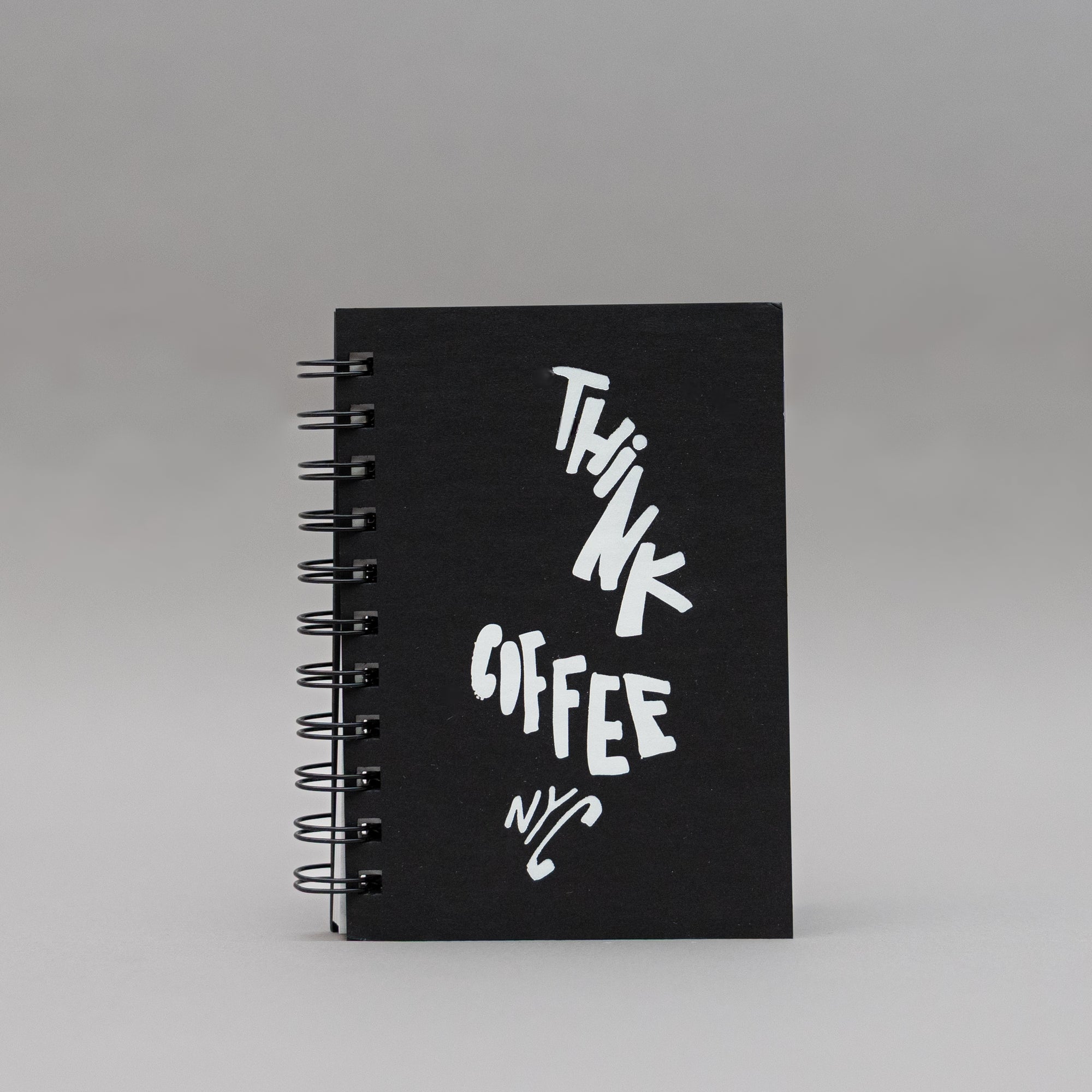 Black notebook with 'Think Coffee NYC' branding.
