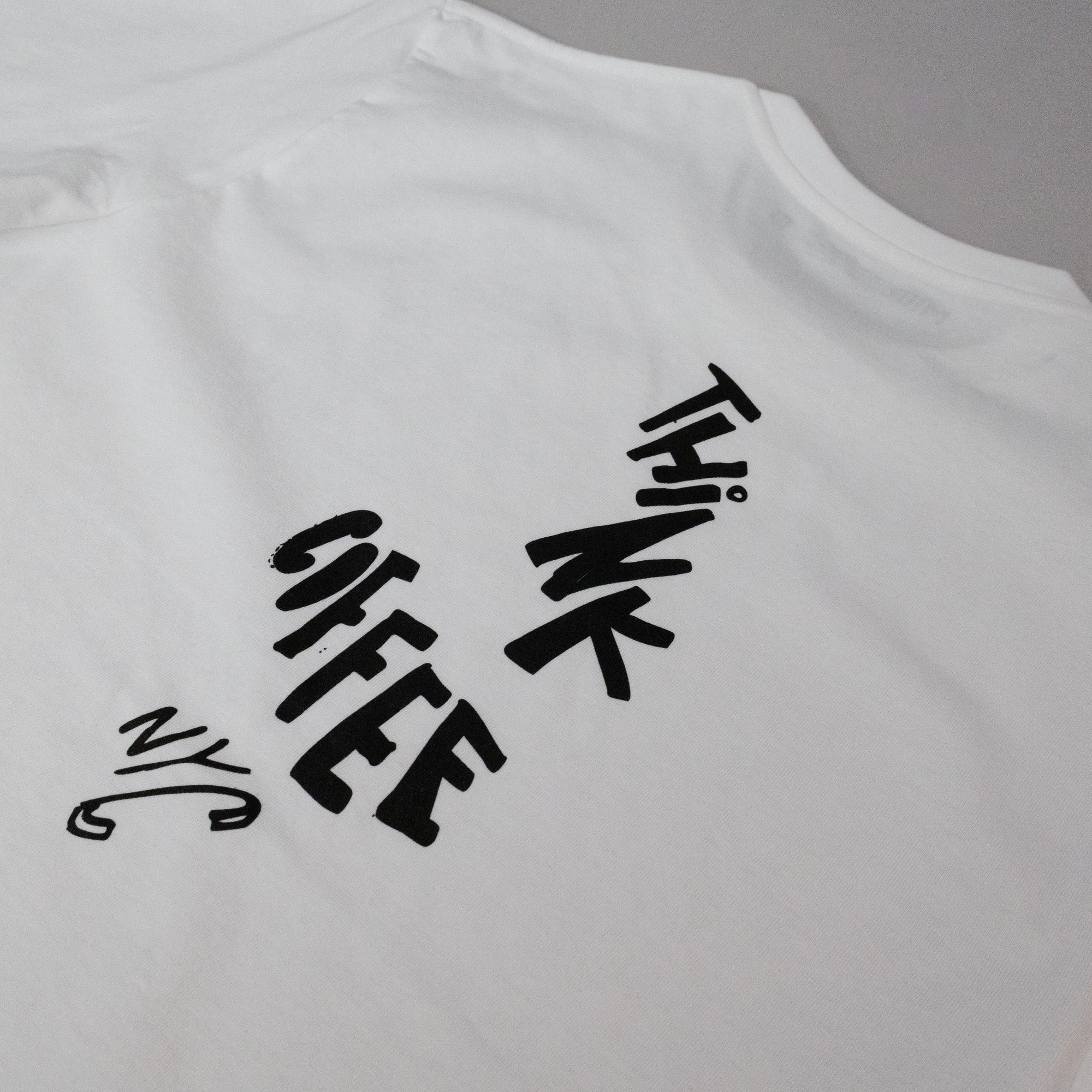 White tank top with black text 'ThinkCoffee NYC' 